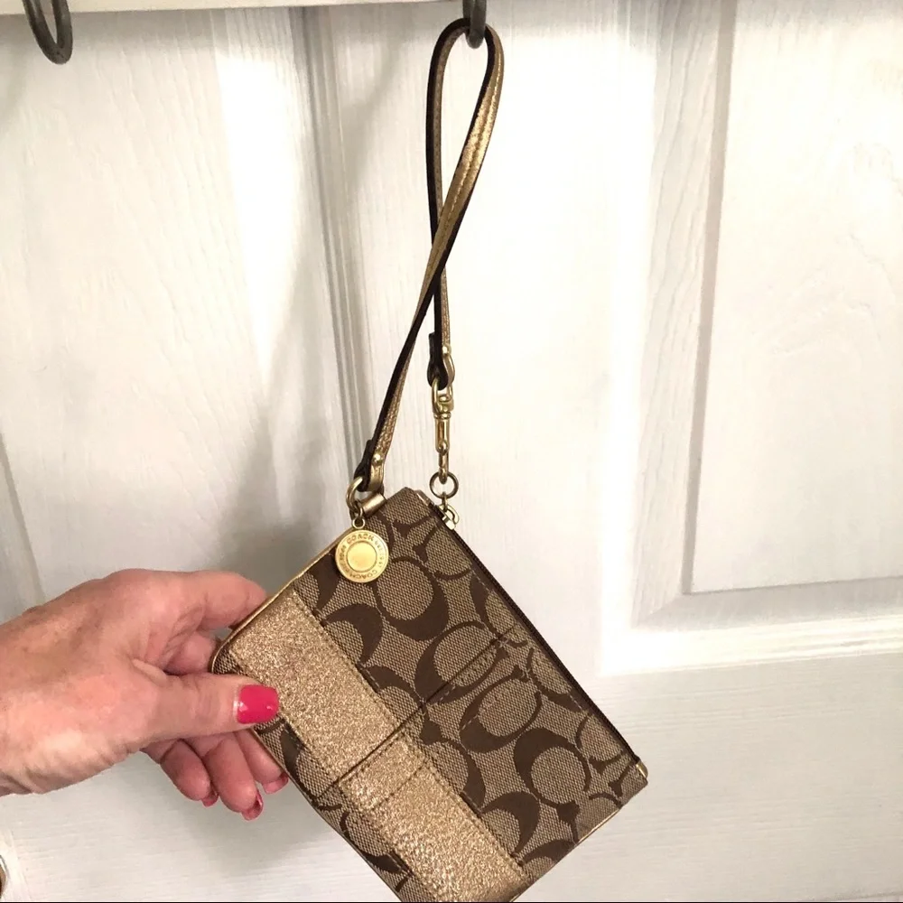 Coach signature tan wristlet, gold strap & stripe